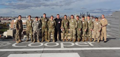 Group of military personnel standing on a rooftop.