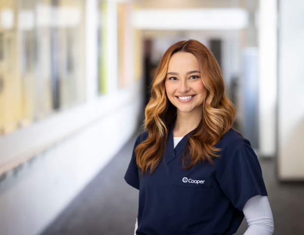 Smiling nurse in blue scrubs