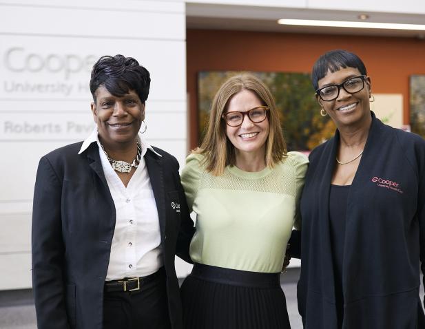 Group of three team members in lobby of Cooper University Hospital Camden