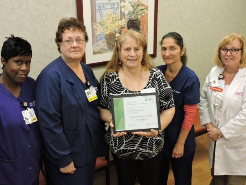 At the award presentation recognizing Cooper University Health Care as a "NJ Breastfeeding-Friendly Worksite are: (l-r) Dawn Caufield, Unit Secretary, Cooper Mother-Infant Unit; Deborah Schoch, PhD, RNC, IBCLC, CCE, CPST, Cooper Lactation Consultant; Judy Schneider, IBCLC, NJ Breastfeeding Coalition; Lisa DiBattista, RN, Cooper Mother-Infant Unit; and Deborah Schoy, RN, Clinical Director, Cooper Mother-Infant Unit.