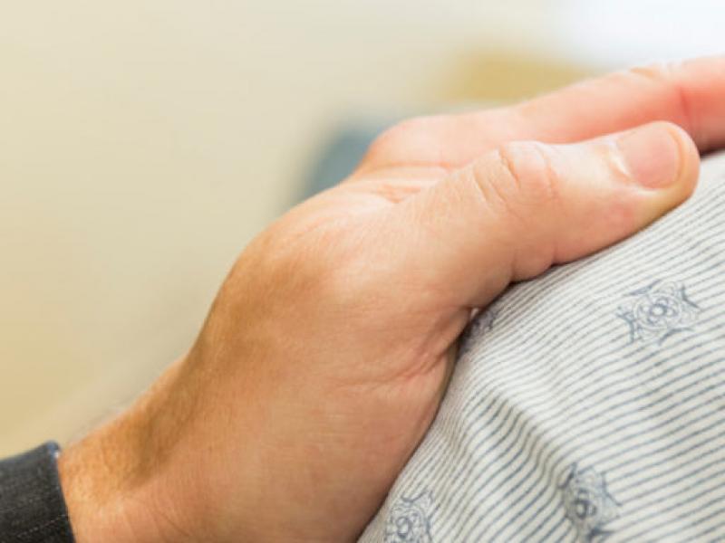 Physician's hand on patient's shoulder