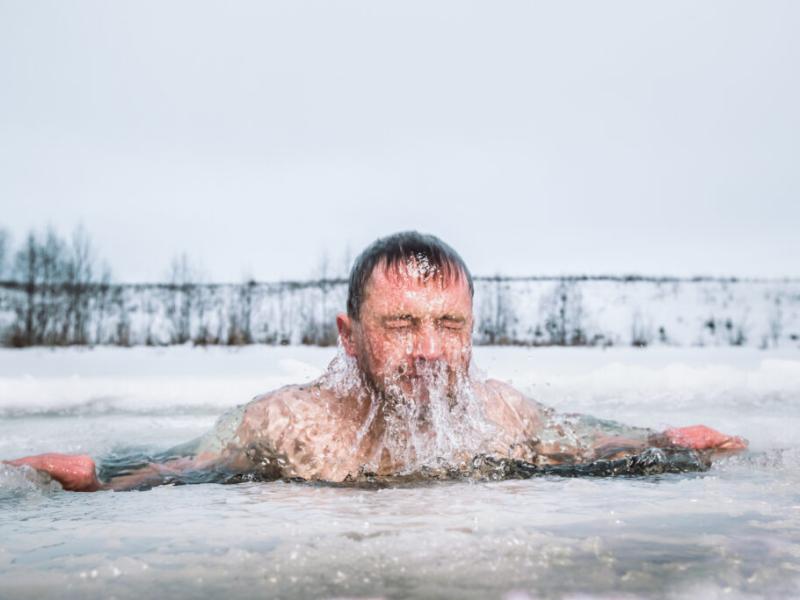 man in an icy lake comes up for air