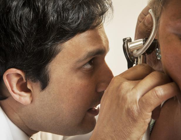 Dr. Ahmad examining patient's ear