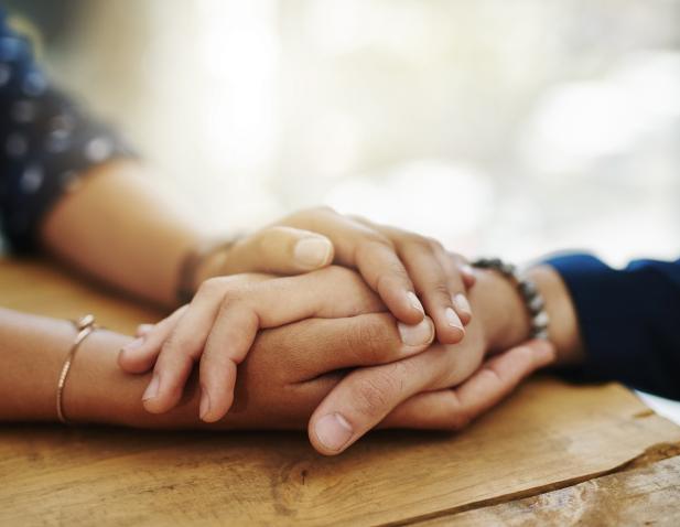 Hands holding in support