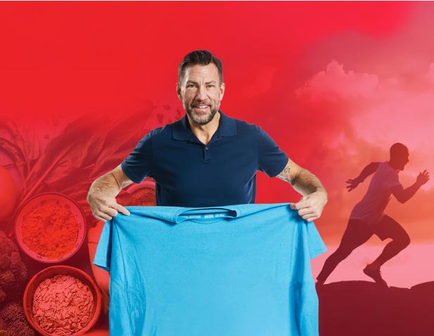 Man smiling and holding up a large blue shirt to show weight loss progress, with a red background featuring healthy foods and a silhouette of a person running.