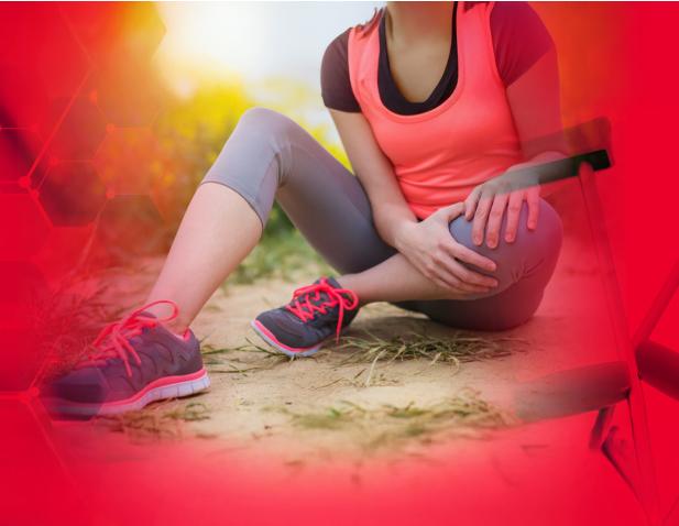 Image of a female sitting on the ground after injuring her leg.