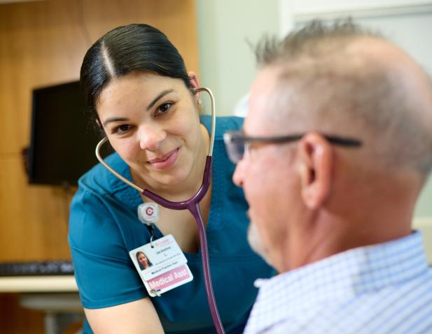 MA patient checking heart stethoscope
