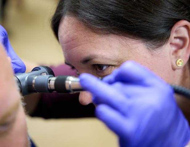 doctor ear exam close up
