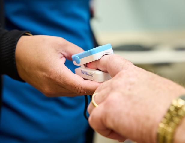 pulse oxygen hands close up patient technician