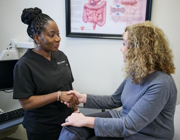 Cooper surgeon speaking with a patient about treatment options in **Southern New Jersey*