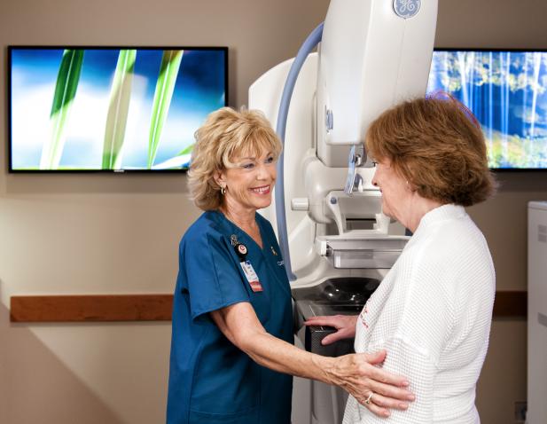 Mammogram technician with patient. 