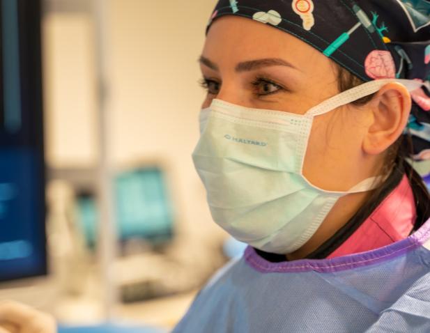 Technician with mask on in operating room