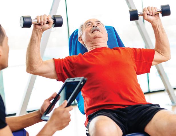 therapist with male patient lifting weights