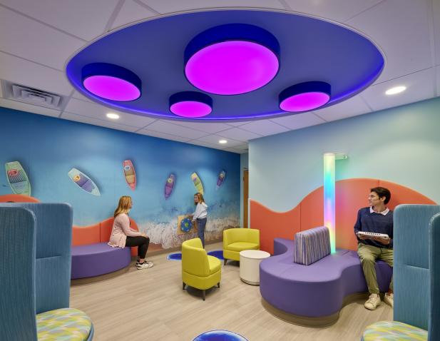 Colorful IDD waiting room with parents and children