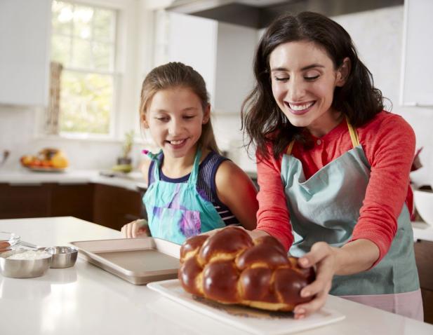 Mother and young daughter baking Challah