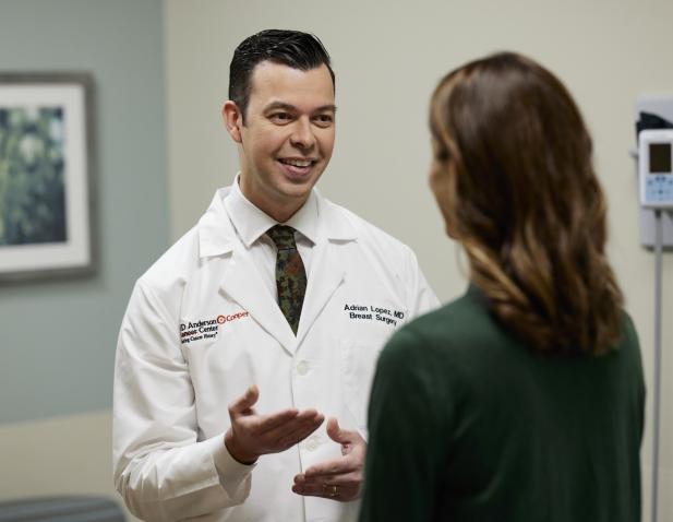 Dr. Adrian Lopez speaking with a female patient