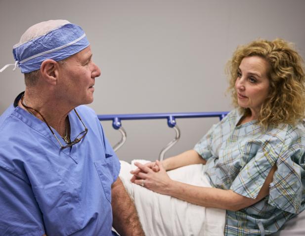 Surgeon speaking with female patient