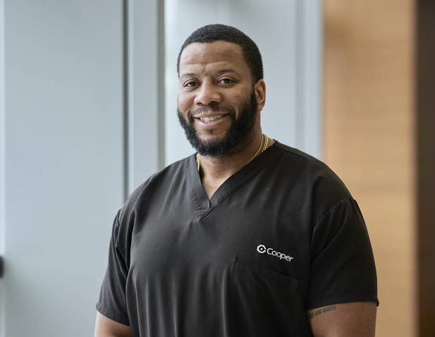 Dr. Ernest Egu facing camera and smiling