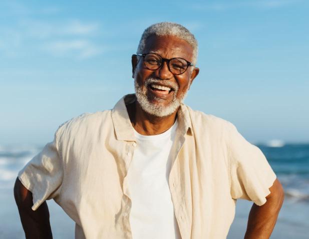 Older happy man on the beach.
