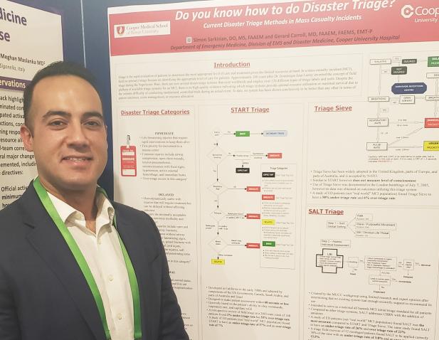 Dr. Simon Sarkisian stands next to a poster presentation titled "Do you know how to do disaster triage?"