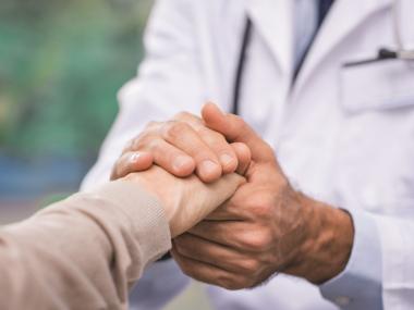 Doctor holding patients hand