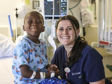 smiling boy with nurse in hospital
