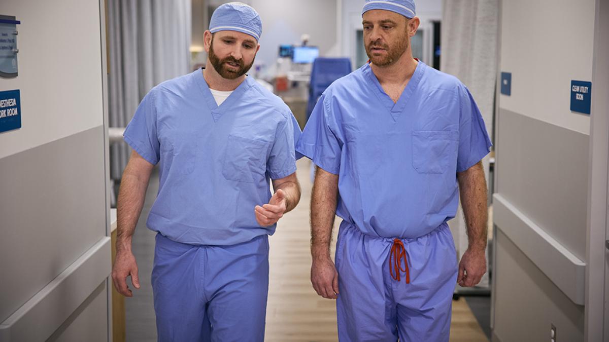 Two male physicians discussing case