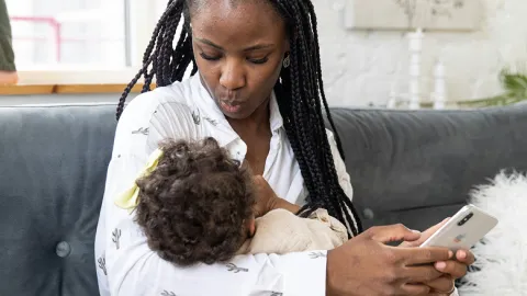 Mother breastfeeding her baby during a private consultation.