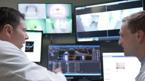 Drs. Dragun and Eastwick at the control desk