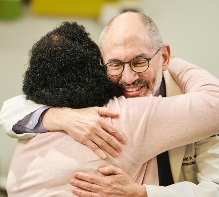 Dr. Warshal hugging patient